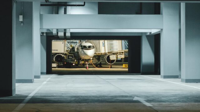 Airplane parked at night in a modern airport terminal gate in Angola.
