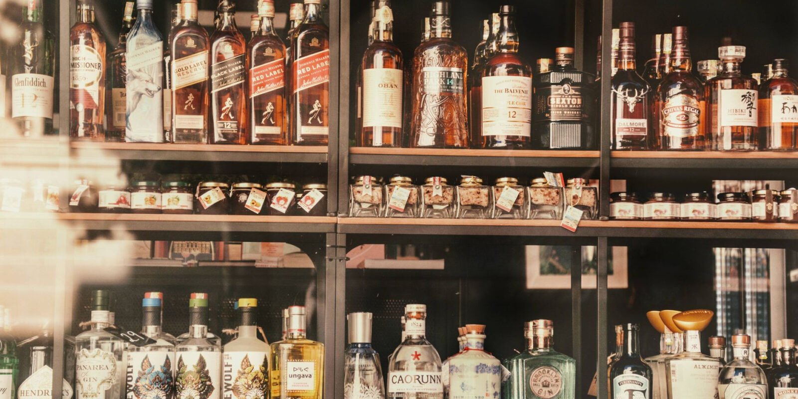 A diverse selection of liquor bottles elegantly displayed on shelves in Valletta, Malta.